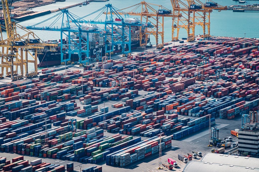 A drone shot of shipping containers at Barcelona Port, Spain, showcasing busy maritime activity.