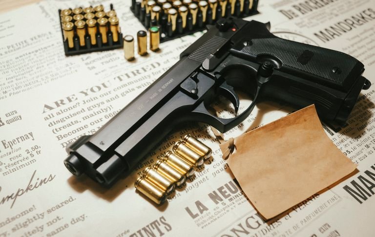 A handgun surrounded by bullets on vintage paper, featuring ammunition clips, conveying a sense of security.